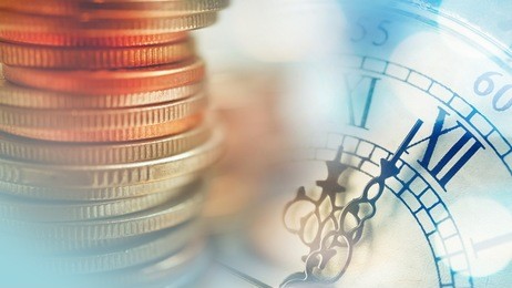 double exposure of clock and rows of coins for time of finance and business concept