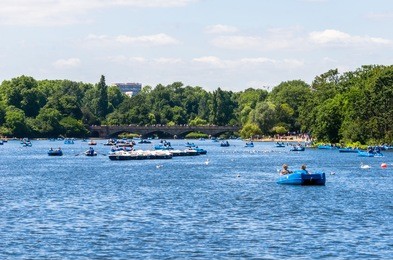 paddling boats on the serpentine lake at hyde park in summer, london