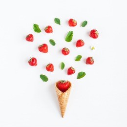 strawberry in waffle cone. creative strawberry on white background. flat lay, top view