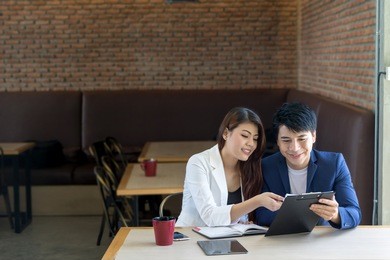asian business man and asian business woman in coffee shop.