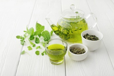 healthy green tea cup with tea leaves 