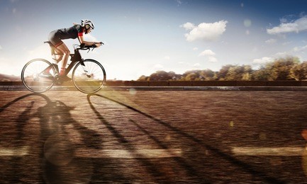 sport. the cyclist rides on his bike at sunset. dramatic background.
