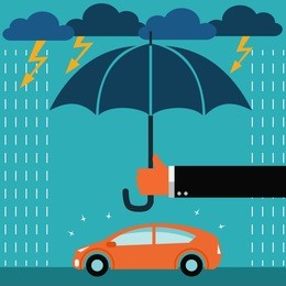 insurance agent standing with umbrella under thunderstorm protecting car