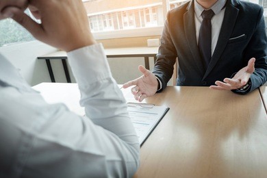 business - young man explaining about his profile to business managers sitting in job interview.
