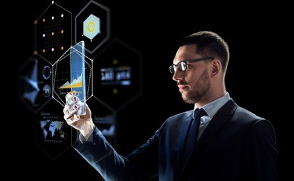 business, augmented reality and future technology concept - businessman in glasses working with transparent tablet pc computer and virtual screens projections over black background