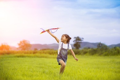 happy family .girl runs kite in summer green pasture.