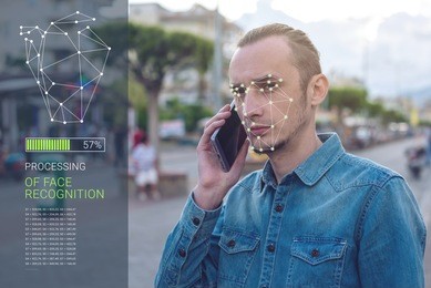 biometric verification. modern young man with the phone. the concept of a new technology of face recognition on polygonal grid is constructed by the points of it security and protection