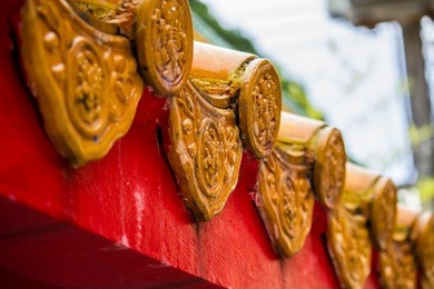 the orange tile roof of a chinese house in thailand and on sky background