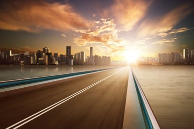 highway overpass motion blur with city skyline background . warm mood .