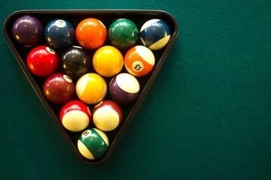 horizontal photo of a billiard table and billiard balls view from above