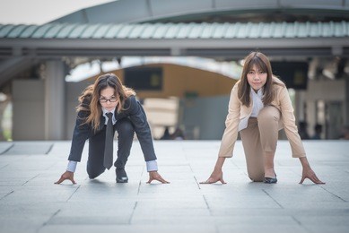 two business woman getting ready for race in business on the city background, business competition concepts.