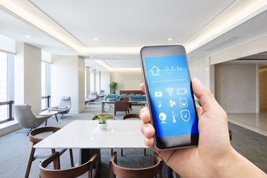 mobile phone with smart home apps in modern meeting room