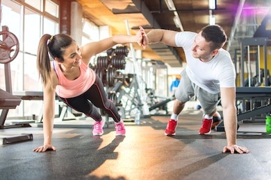 young sporty couple working out together at gym.