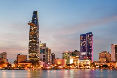 ho chi minh city skyline and the saigon river at sunset. colorful view of skyscraper and other modern buildings at downtown. ho chi minh city is a popular tourist destination of vietnam.
