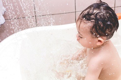 mother washing shower with baby in bath