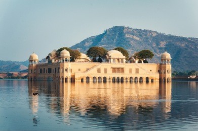 jal mahal, jaipur, rajasthan, india. palace on the water of man sagar lake with mountain on the background. famous travel and tourist attraction