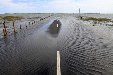 floods have flooded a street. flooding on a road