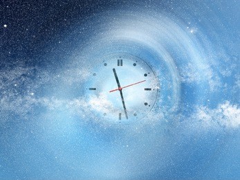 conceptual image of abstract lights and clock in space. nasa space image manipulated and layered; www.nasa.gov