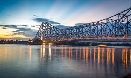 howrah bridge - the historic cantilever bridge on the river hooghly with twilight sky. howrah bridge is considered as the busiest bridge in india.