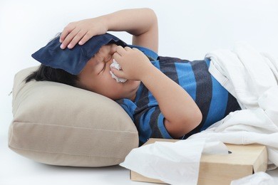 little asian sick boy fever and blowing her nose in bed