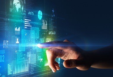 female finger touching a beam of light surrounded by blue and green data and charts