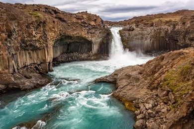 view of aldeyjarfoss waterfall among the rocks in iceland