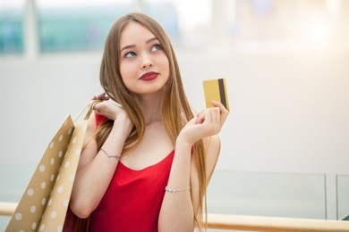 woman holding credit card, shopping bag, in shoping mall.