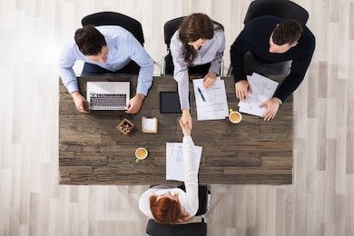 group of corporate recruitment officers shaking hand with candidate arrived for interview