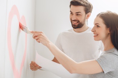 young couple doing apartment repair together themselves