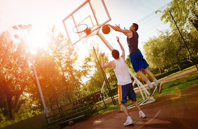 two street basketball players having training outdoor. they are making a good action.