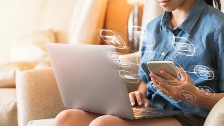 internet of things - iot and digital marketing via multi-channel communication network concept with young girl easily using computer and mobile smart device app technology at home 