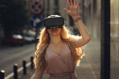 blonde girl using cool vr set to experience living in fantasy computer game left amazing sights of the fantasy location oculus vr technology vr gear digital 3d video vr headset 360 video business