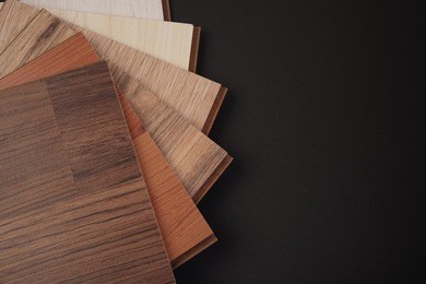 samples of floor wood panels on black background with copy space. interior design or renovation concept.