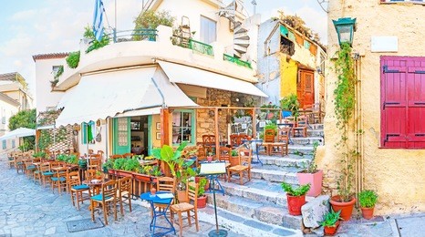 panorama of cozy outdoor cafe in plaka, the best place to walk and relax with a cup of greek coffee, athens, greece.