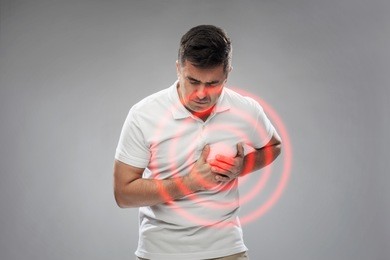 people, healthcare and problem concept - unhappy man suffering from heart ache over gray background