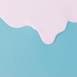 abstract pink oil paint texture on blue canvas. minimalistic background with copy space.