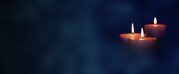 candle lights in blue darkness for contemplative moments