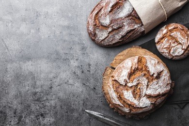 delicious freshly baked bread on rustic background