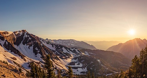panorama of a summer sunset in the mountains at snowbird ski and summer resort, little cottonwood canyon, utah.