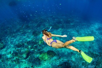 happy family - girl in snorkeling mask dive underwater with tropical fishes in coral reef sea pool. travel lifestyle, water sport outdoor adventure, swimming lessons on summer beach holiday with kids