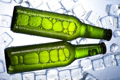 bottles of beer, three fresh beer with ice