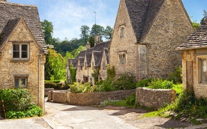 scenic view on   old street in sunny morning,  bibury, gloucestershire, england, uk