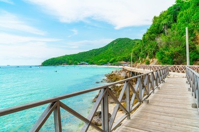 wooden bridge with beautiful tropical beach at koh larn in pattaya, thailand.