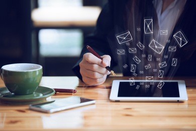 white smart phone on a wooden table emitting holographic image of social media related icons