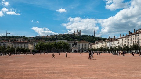 the open square of la place bellecour in the center of lyon, france.  this is the third largest square in france with the equestrian statue of louis xiv in the middle.