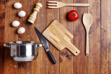 flat photo of kitchen tools on brown desk space 