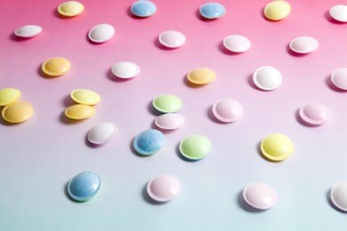 flying saucer multicolored candy sweets on a gradient background pink and blue.
minimal color still life photography