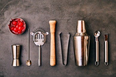 set of cocktail bar utensils and vessels with bowl of cherries