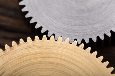 closeup photo of two interlocking metal gears
