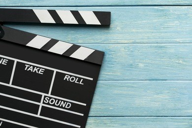 movie clapper on wood table ; film, cinema and video photography concept